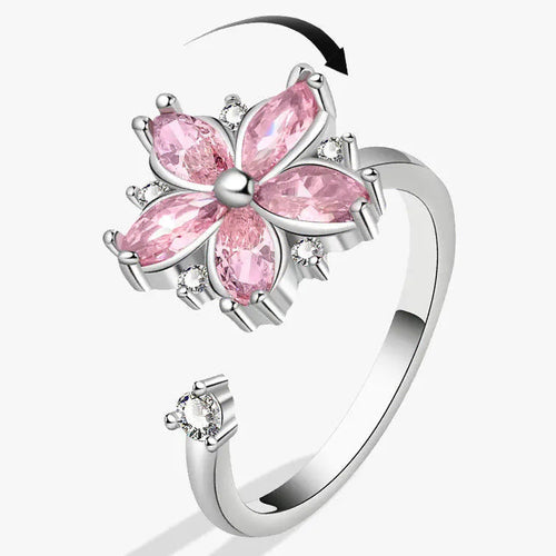 Verstelbare ring met anti-stress draaibloem in roze kristallen