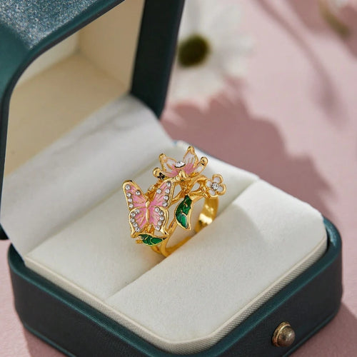 Verstelbare ring met kersenbloesem en vlinder in goud