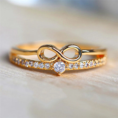 Dubbele ring en oneindigheidssymbool in goud