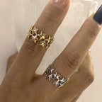 Brede ring met meerdere sterren goud