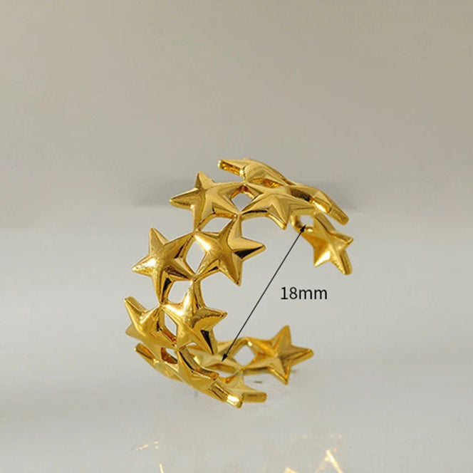Brede ring met meerdere sterren goud