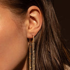 Boucles d'oreilles à pompons sublimant le visage