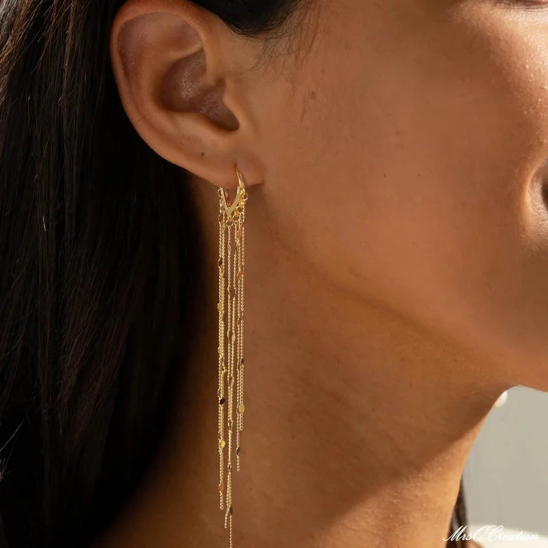 Boucles d'oreilles à pompons sublimant le visage