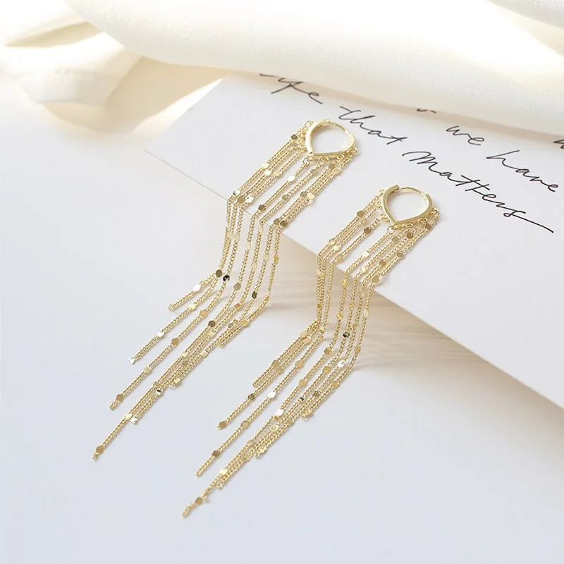 Boucles d'oreilles à pompons sublimant le visage