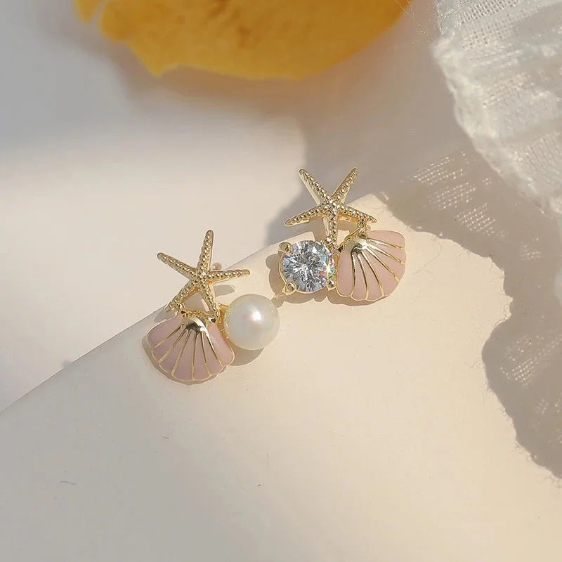 Asymmetrische schelp oorbellen roze