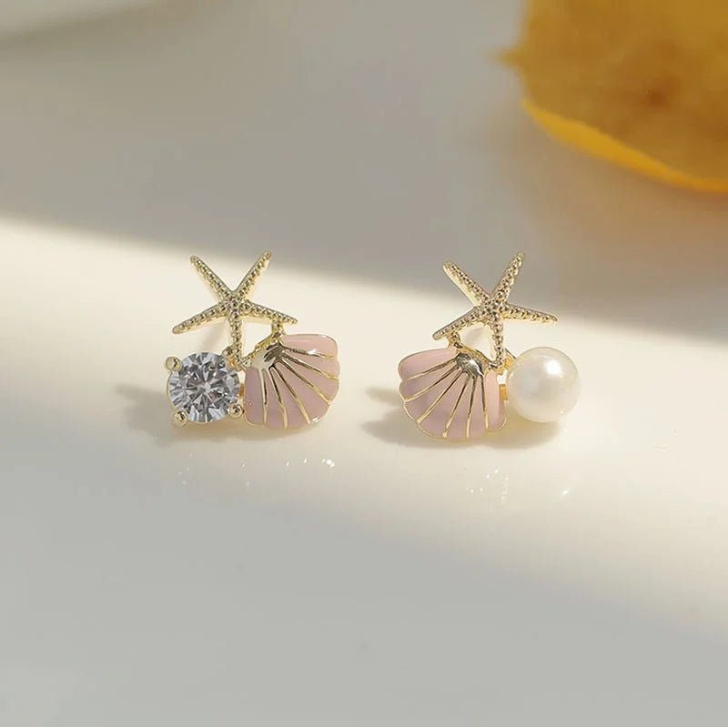 Asymmetrische schelp oorbellen roze