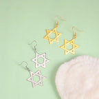 Zeshoekige hangende oorbellen met het Joodse symbool van de gouden <span data-glossary-id="star-of-david">Davidster</span>