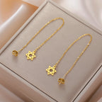 Lange hangende oorbellen met de <span data-glossary-id="star-of-david">Davidster</span> joods symbool goud