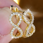 Hangende oorbellen met sprankelend oneindigheidssymbool goud