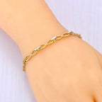 Armband met ineengestrengelde oneindigheidssymbolen goud