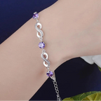 Armband met paarse kralen en oneindigheidssymbolen versierd met kristallen 
