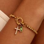 Armband met kruis en geboortesteen van december
