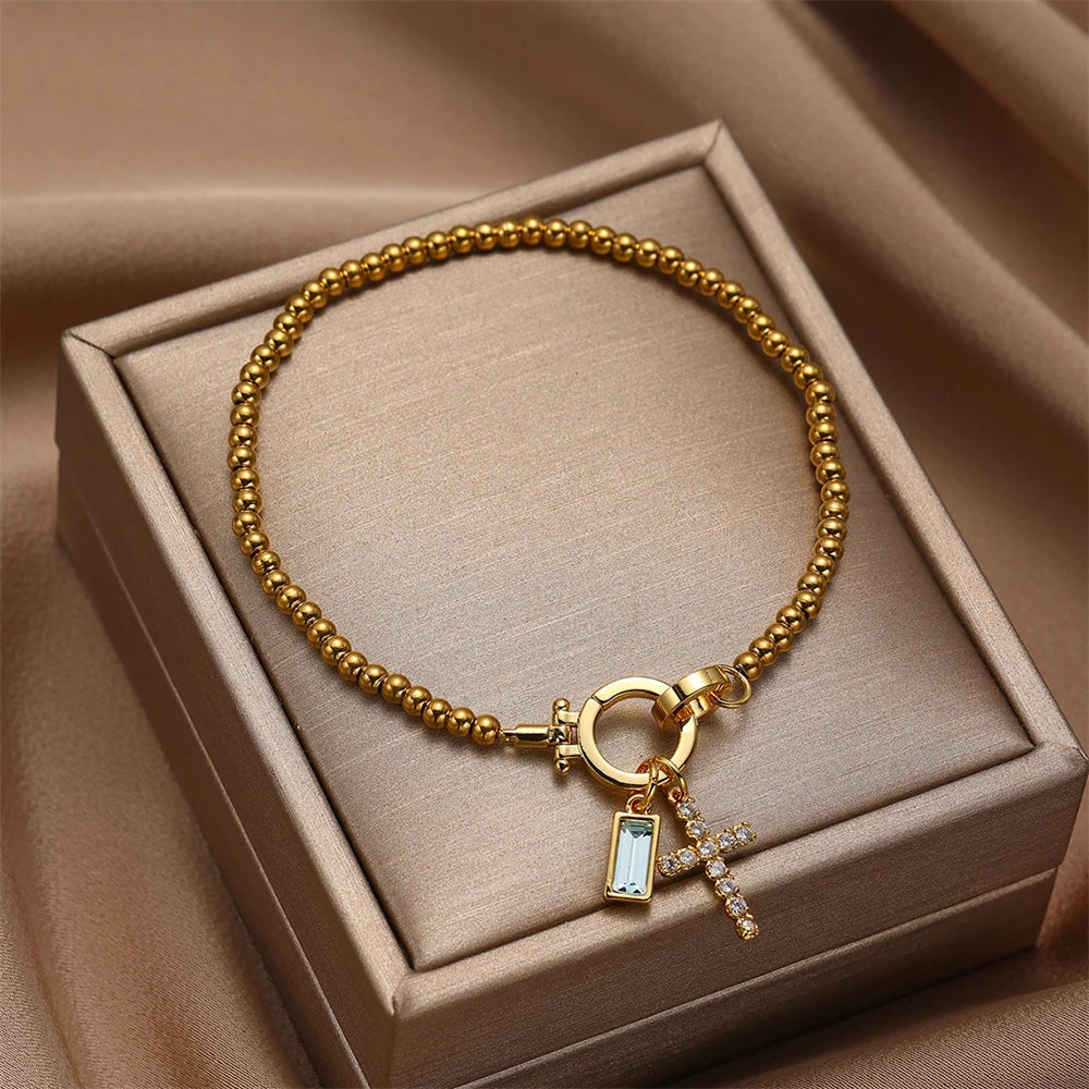 Armband met kruis en geboortesteen