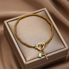 Armband met kruis en geboortesteen