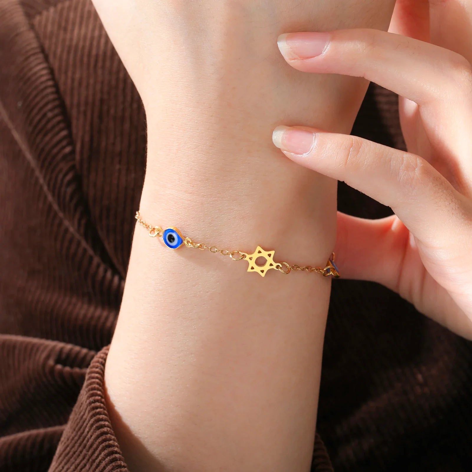 Armband met beschermsymbolen blauwe oog, Chai en de Davidster goud