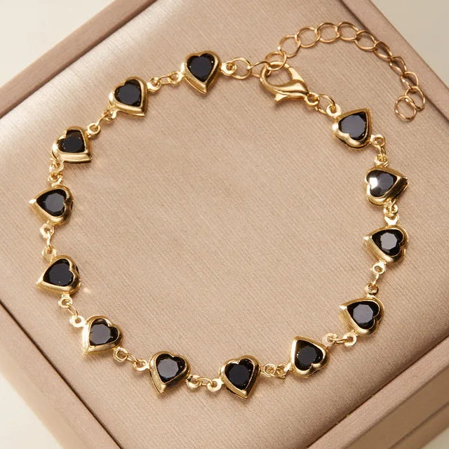 Armband met geëmailleerde hartjes goud en zwart