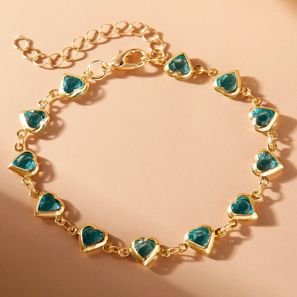 Armband met geëmailleerde hartjes goud en groen