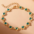 Armband met geëmailleerde hartjes goud en groen