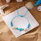 Koordarmband met schelp en blauwe zeester