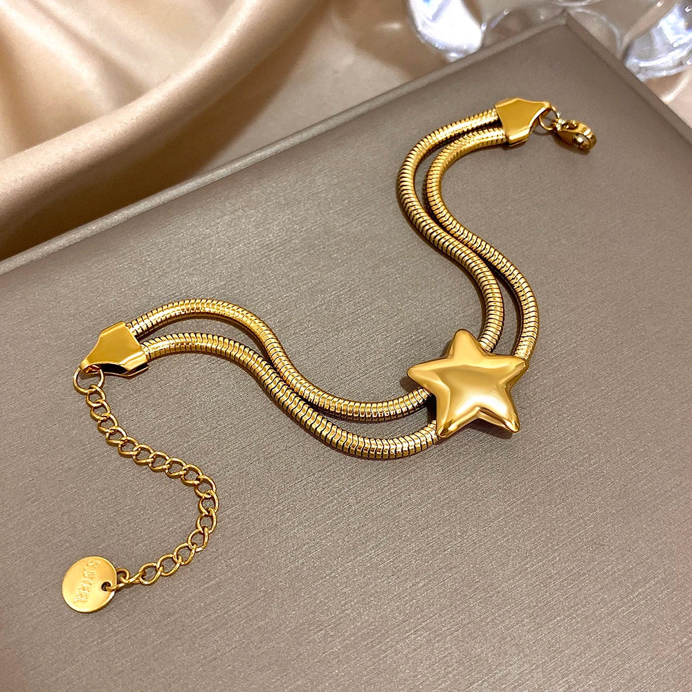 Armband met dubbele rij en bolle ster goud