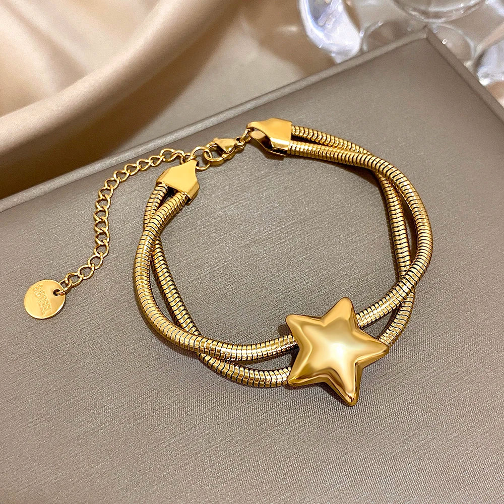 Armband met dubbele rij en bolle ster goud