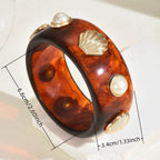 Armband van hars met schelp