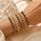 Armband met meerdere klavertjes van gekleurde kristallen goud en groen