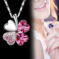 Ketting met grote klavervormige hanger met vier harten in roze gekleurde kristallen