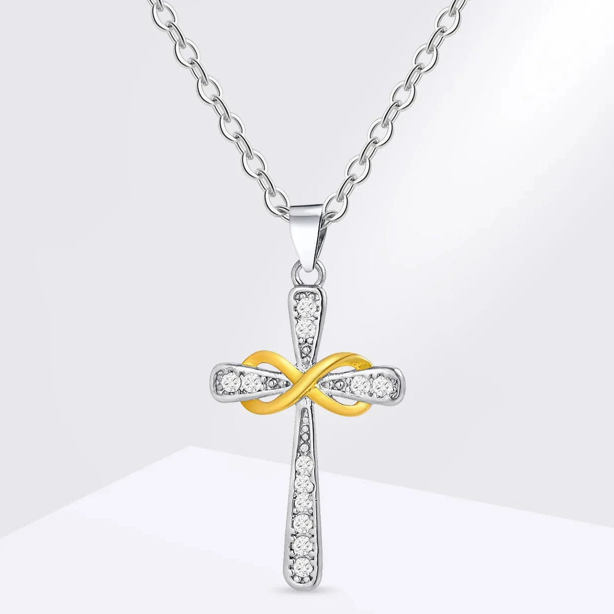 Ketting met hanger in de vorm van een kruis en tweekleurig oneindigheidssymbool