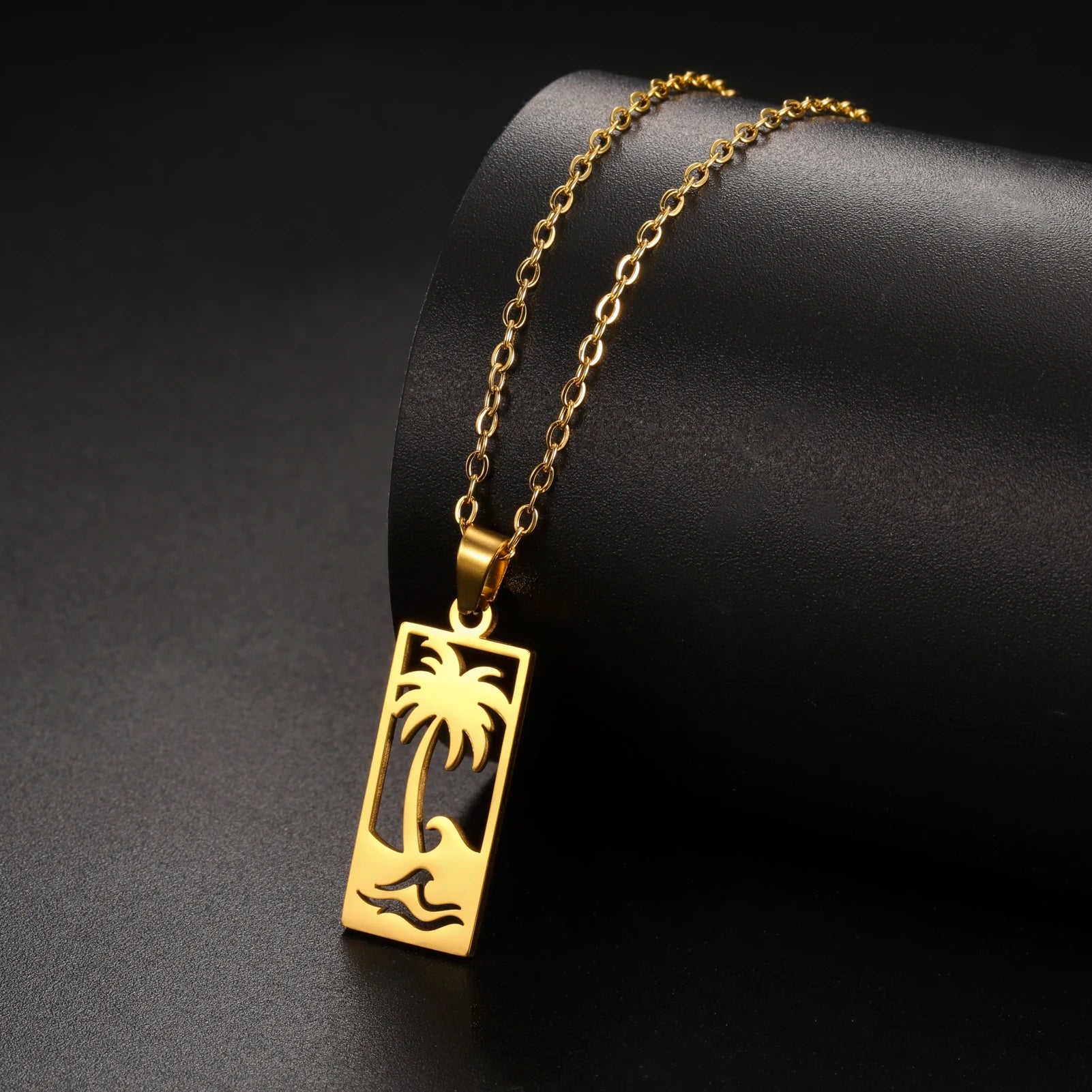 Ketting met palmboom- en strandgolfhanger goud