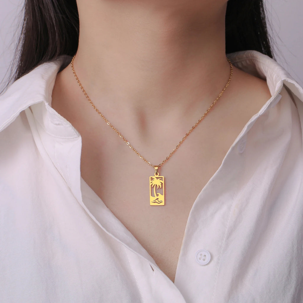 Ketting met palmboom- en strandgolfhanger goud
