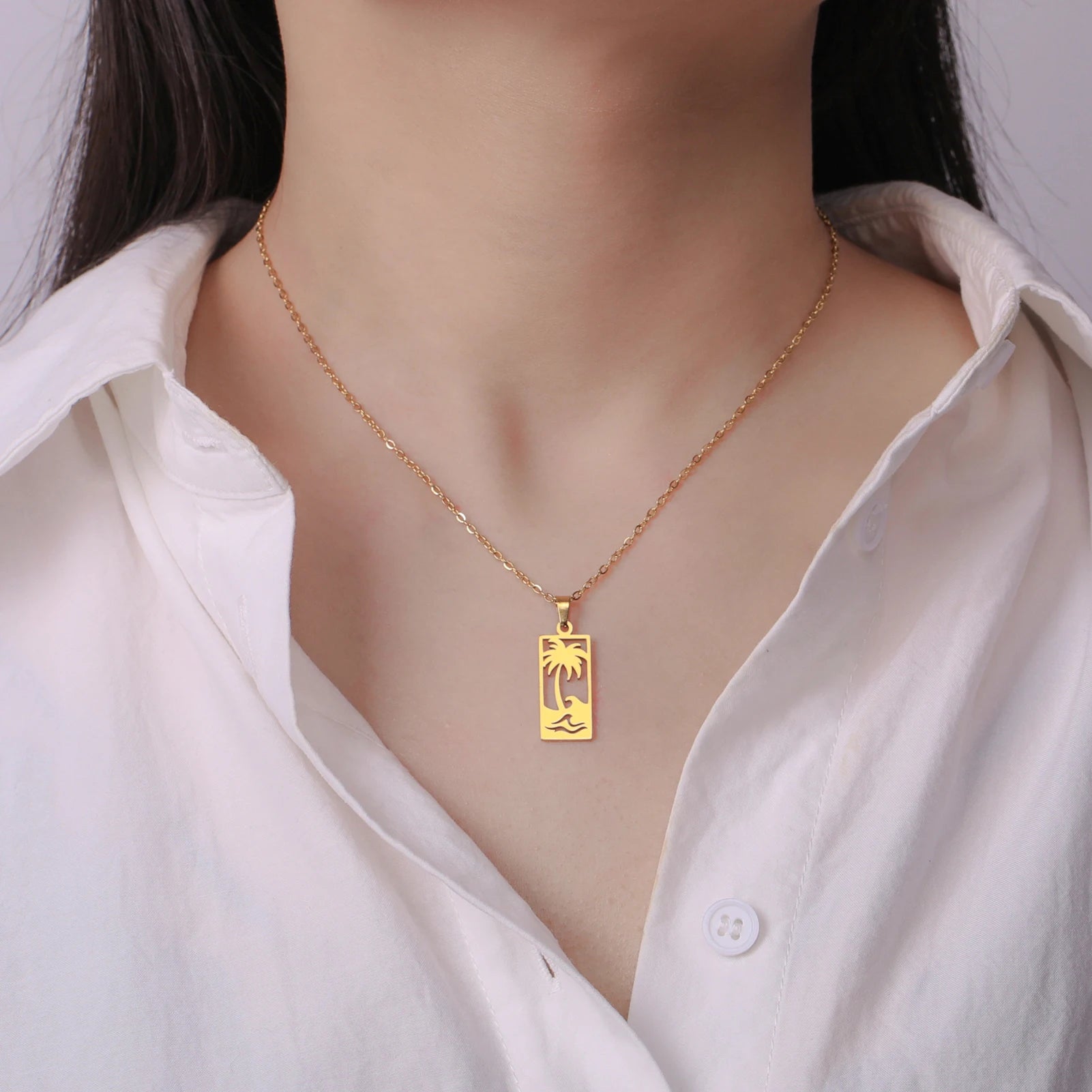 Ketting met palmboom- en strandgolfhanger goud