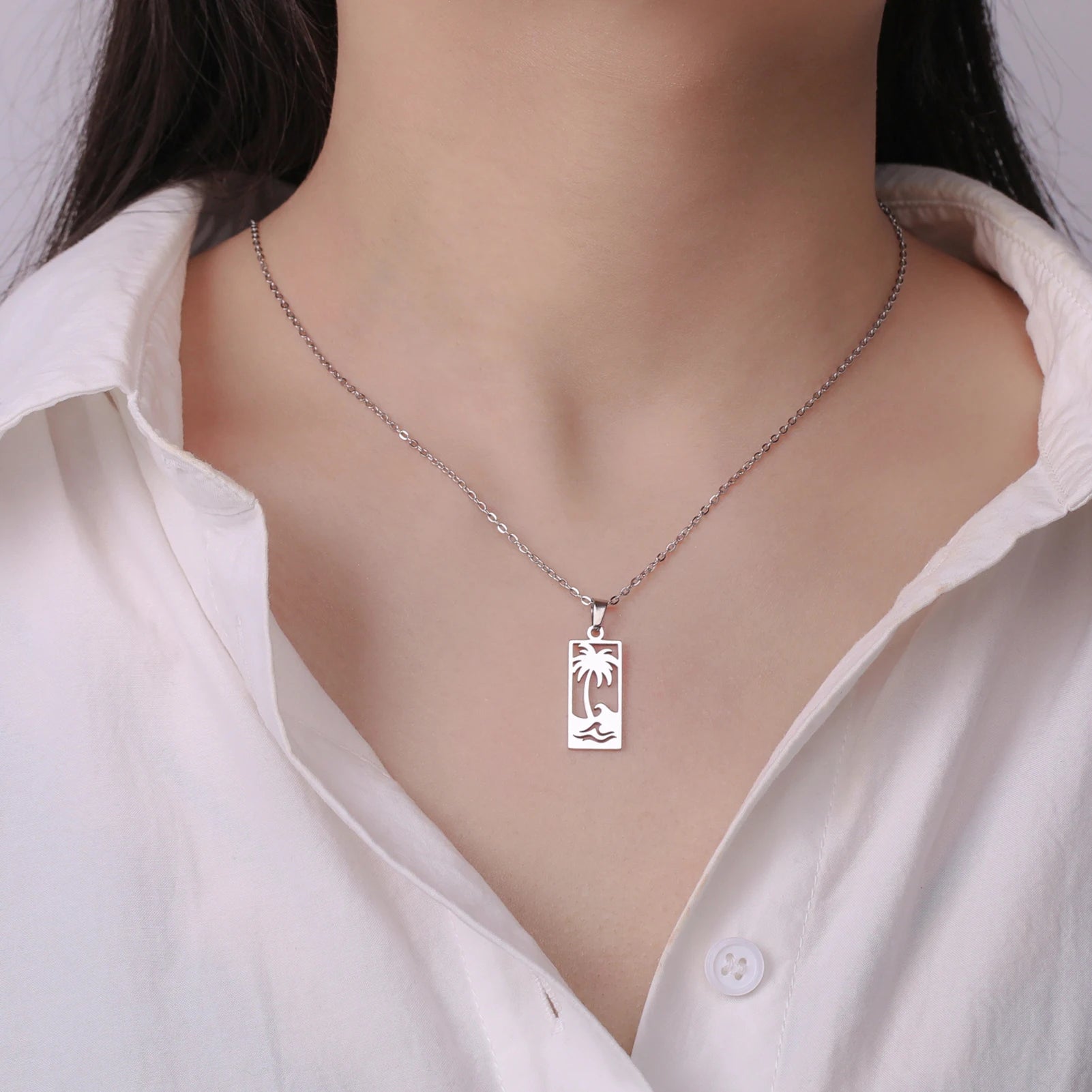 Ketting met palmboom- en strandgolfhanger zilver