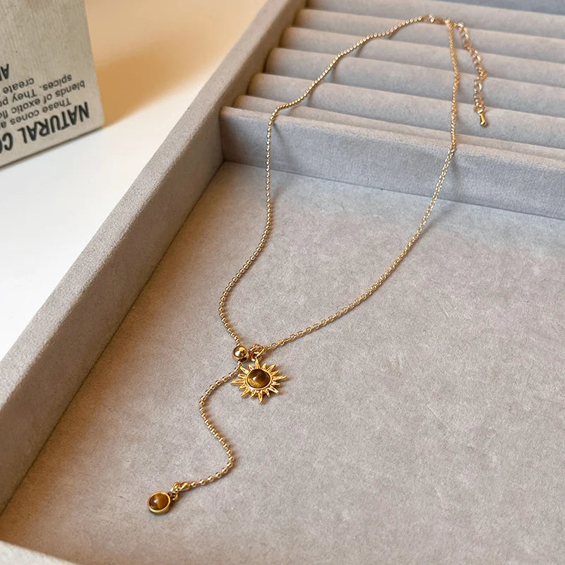Lariatketting met zonster-hangers en tijgeroogstenen