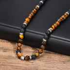 Ketting van lavastenen en tijgeroog met lotusbloemhanger