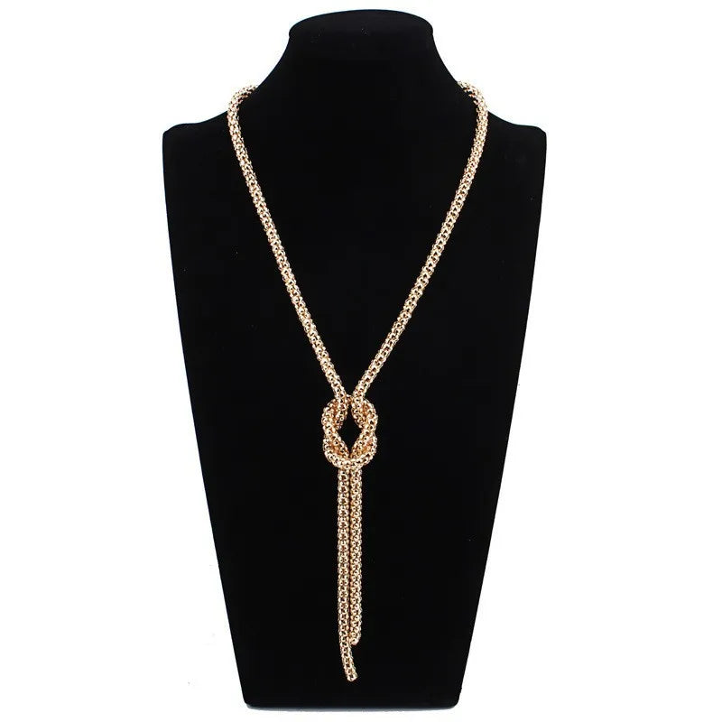 Lange ketting met knoop-hanger in goud