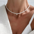 Choker met witte parel en hartvormige hanger