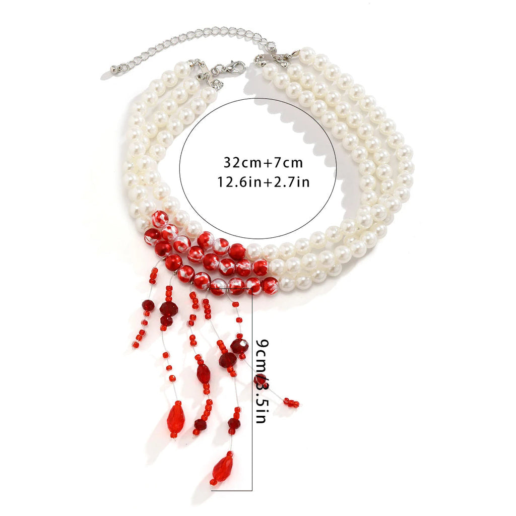 Drievoudige ketting met hangertje van vallende parels