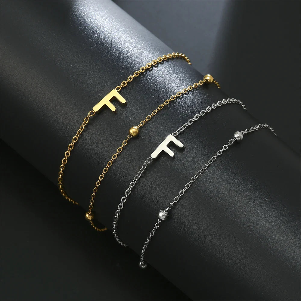 Dubbele initiaal armband goud en zilver  f