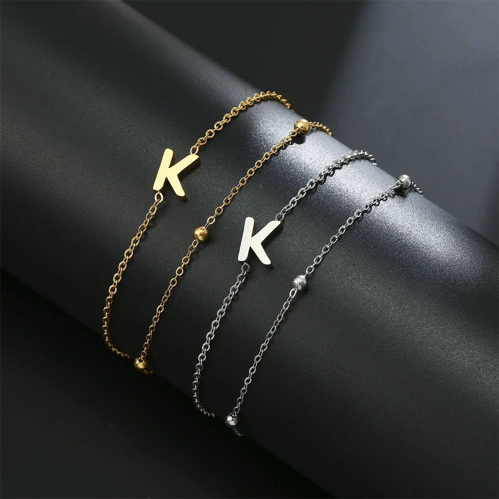 Dubbele initiaal armband goud en zilver k