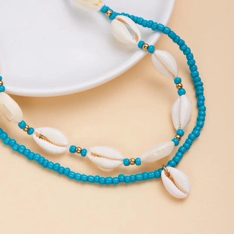 Dubbele ketting met kaurischelp turquoise