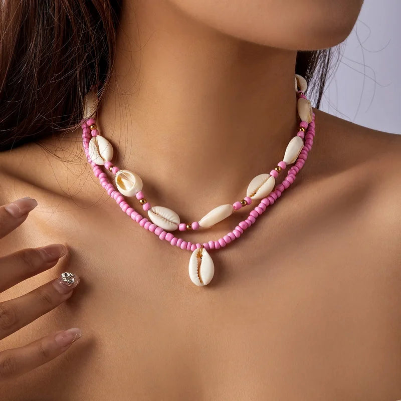 Dubbele ketting met kaurischelp roze