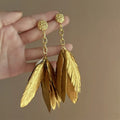 Grote vergulde oorbellen met veren