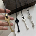 Lange koordketting met sleutelhanger in goud