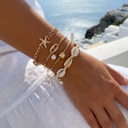 Set van 5 gouden schelp- en sterarmbanden